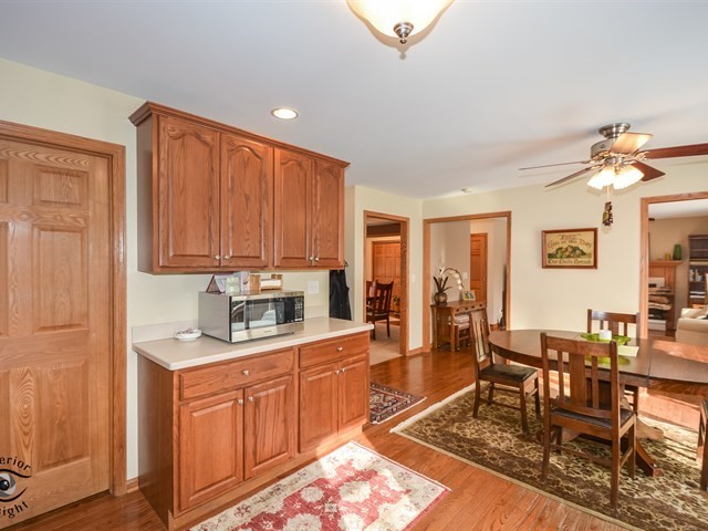 312 Main Street Oswego, IL 60543 - Photo 15 of 29 a kitchen with granite countertop a stove a sink dishwasher a dining table and chair with wooden floor