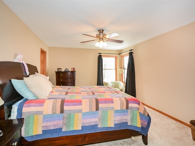 312 Main Street Oswego, IL 60543 - Photo 16 of 29 a bedroom with a bed and a chandelier