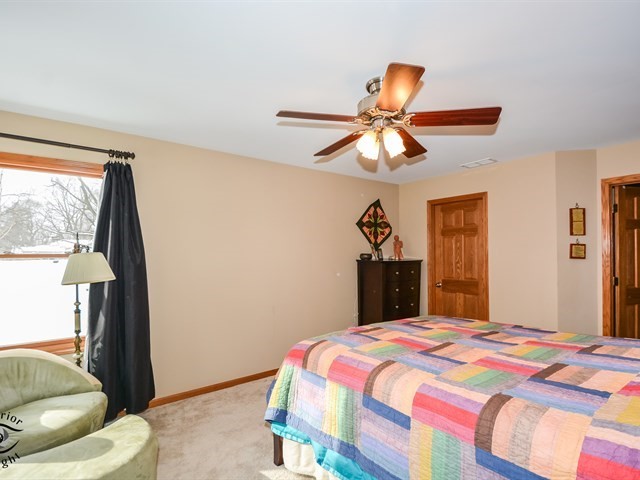 312 Main Street Oswego, IL 60543 - Photo 17 of 29 a bedroom with a bed and a chandelier