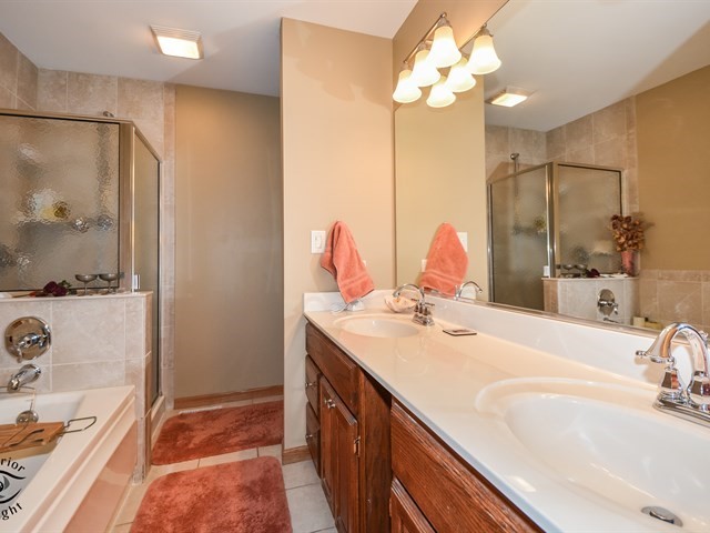 312 Main Street Oswego, IL 60543 - Photo 18 of 29 a bathroom with a double vanity sink and a mirror