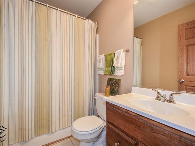 312 Main Street Oswego, IL 60543 - Photo 22 of 29 a bathroom with a sink a toilet and shower curtain