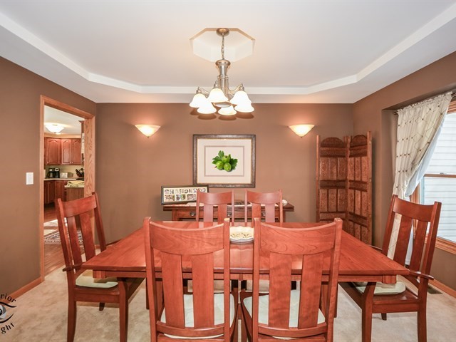 312 Main Street Oswego, IL 60543 - Photo 7 of 29 a view of a dining room with furniture and chandelier