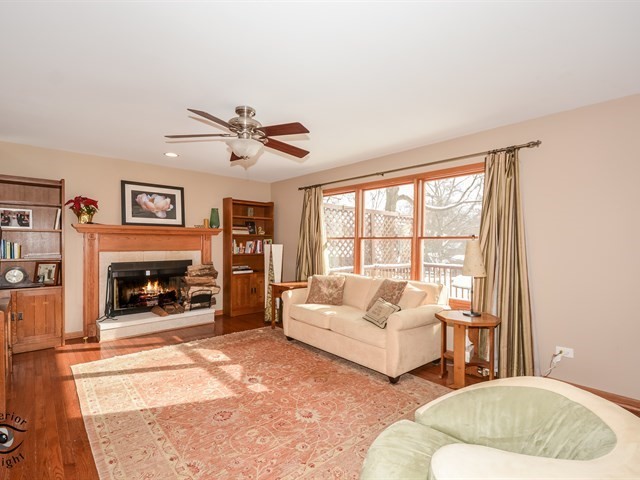 312 Main Street Oswego, IL 60543 - Photo 9 of 29 a living room with furniture large window and a fireplace