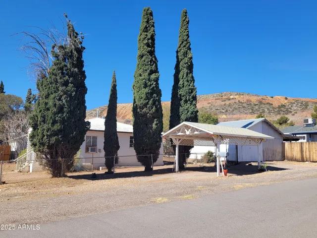 a view of a house with a garden and pathway