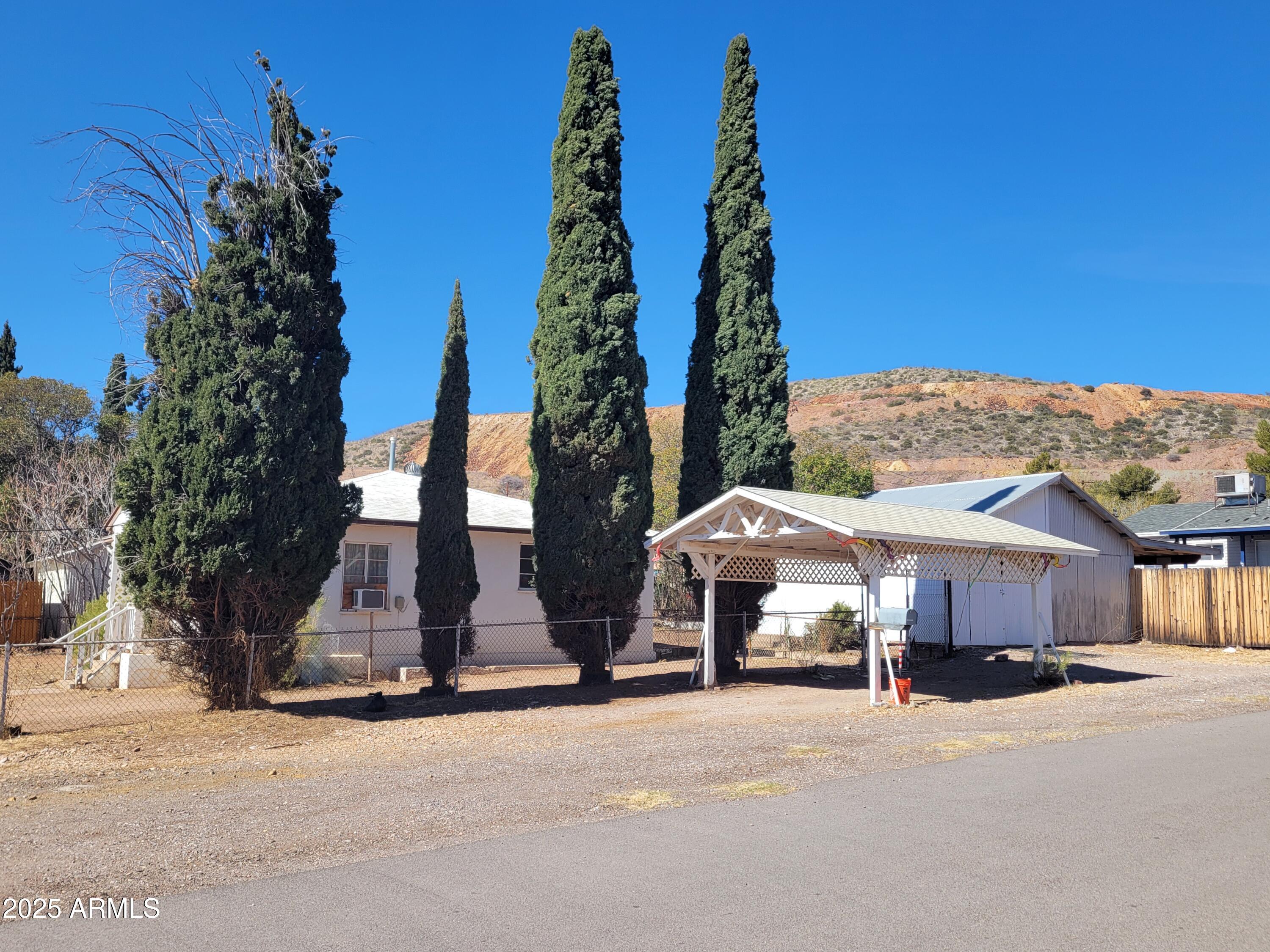 53 Spray Avenue Bisbee, AZ 85603 - Photo 1 of 21 a view of a house with a garden and pathway