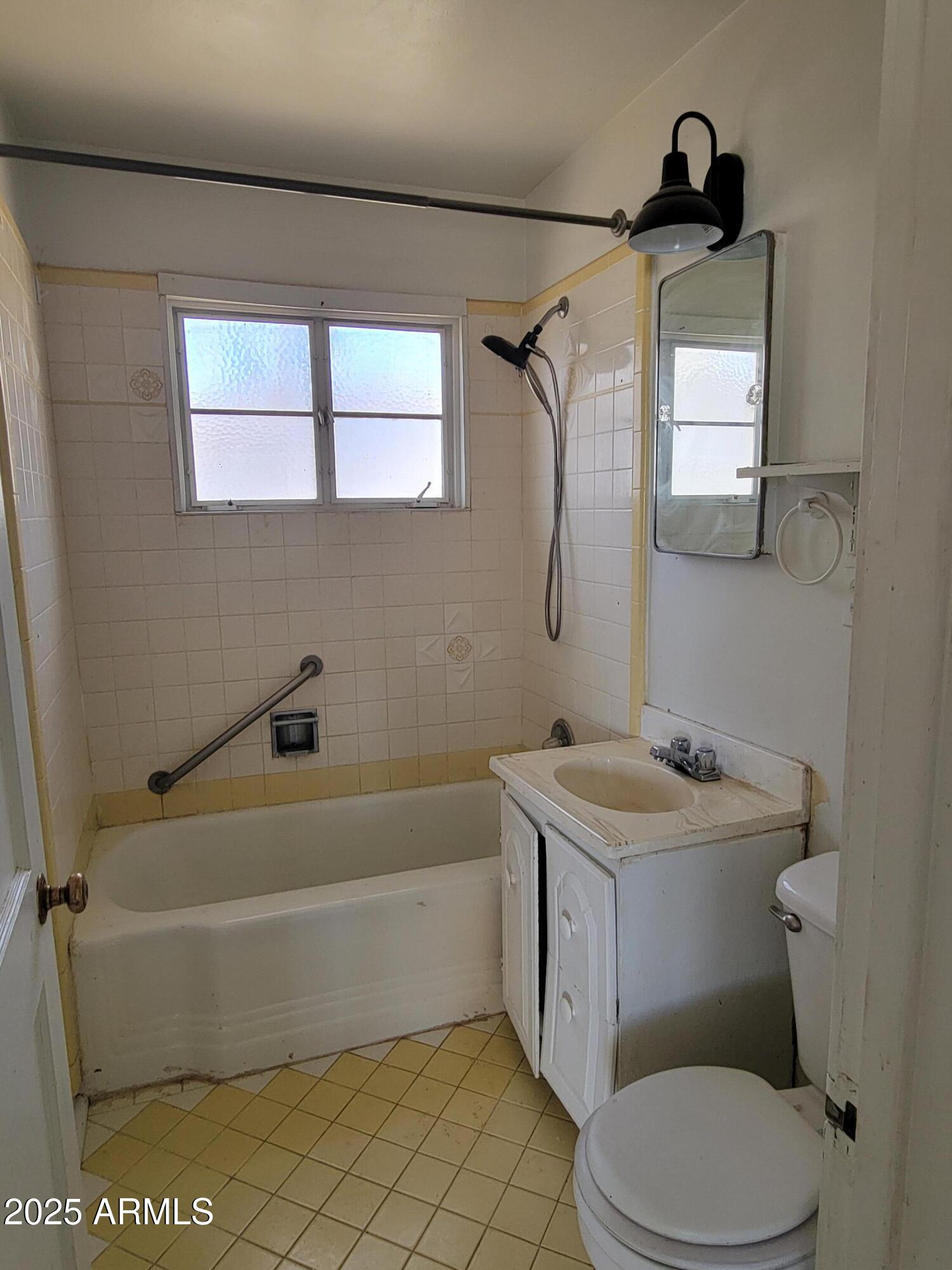 53 Spray Avenue Bisbee, AZ 85603 - Photo 12 of 21 a bathroom with a sink a toilet and a bathtub