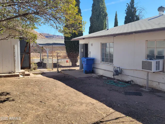 a view of a house with snow on the road