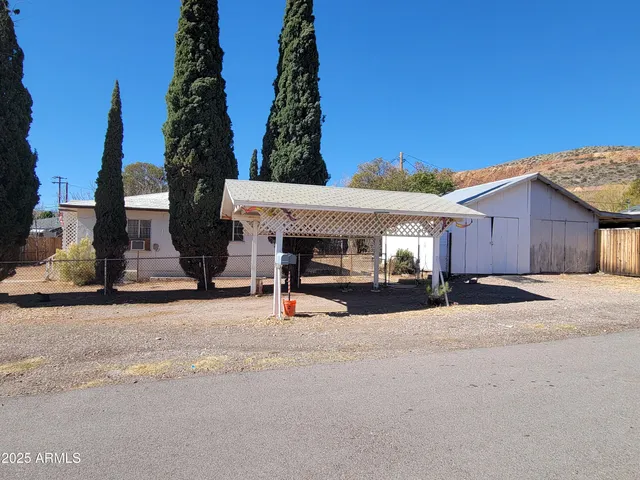 a view of a house with backyard and garage