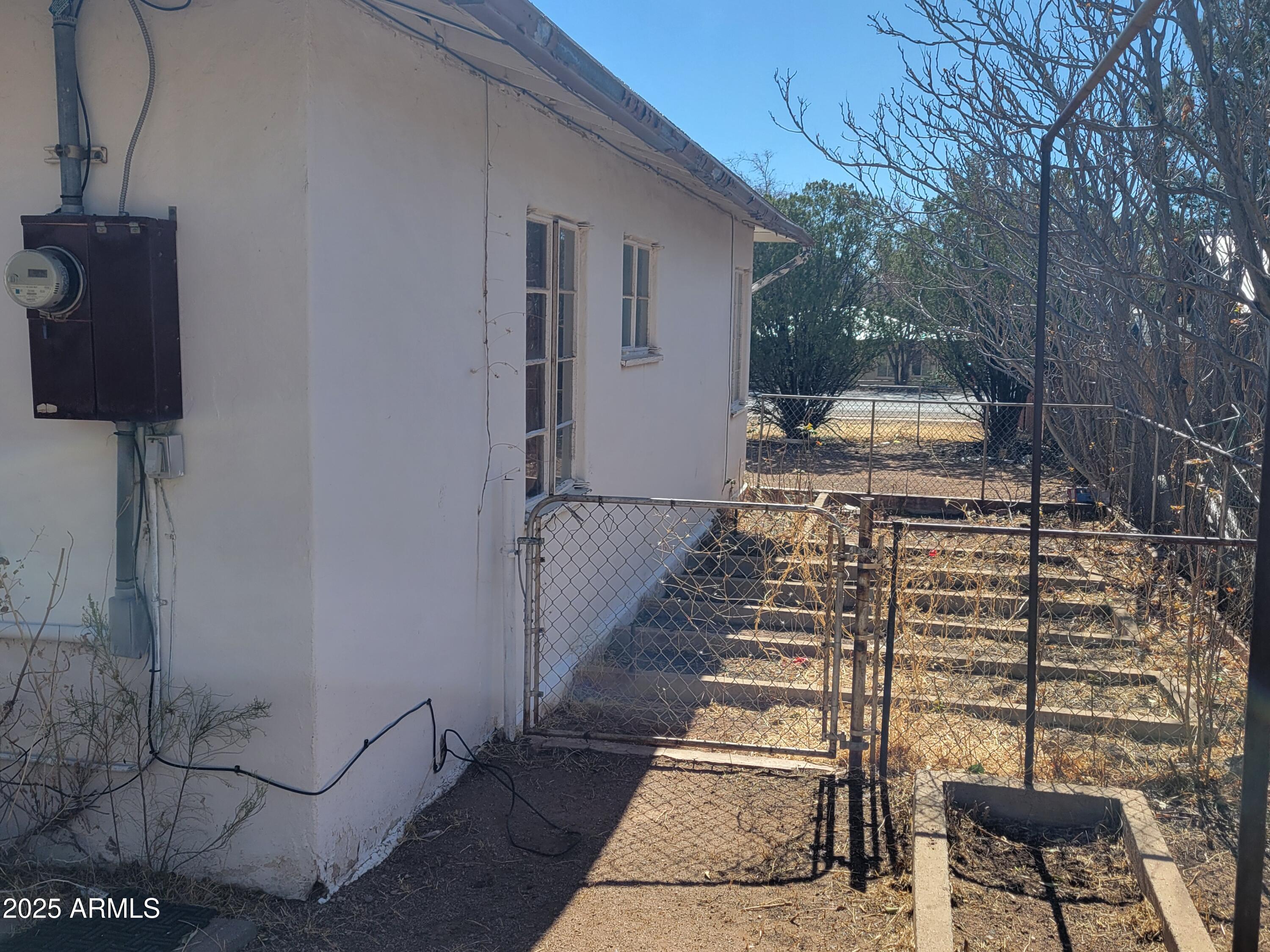53 Spray Avenue Bisbee, AZ 85603 - Photo 20 of 21 a view of a patio with table and chairs with wooden floor and plants