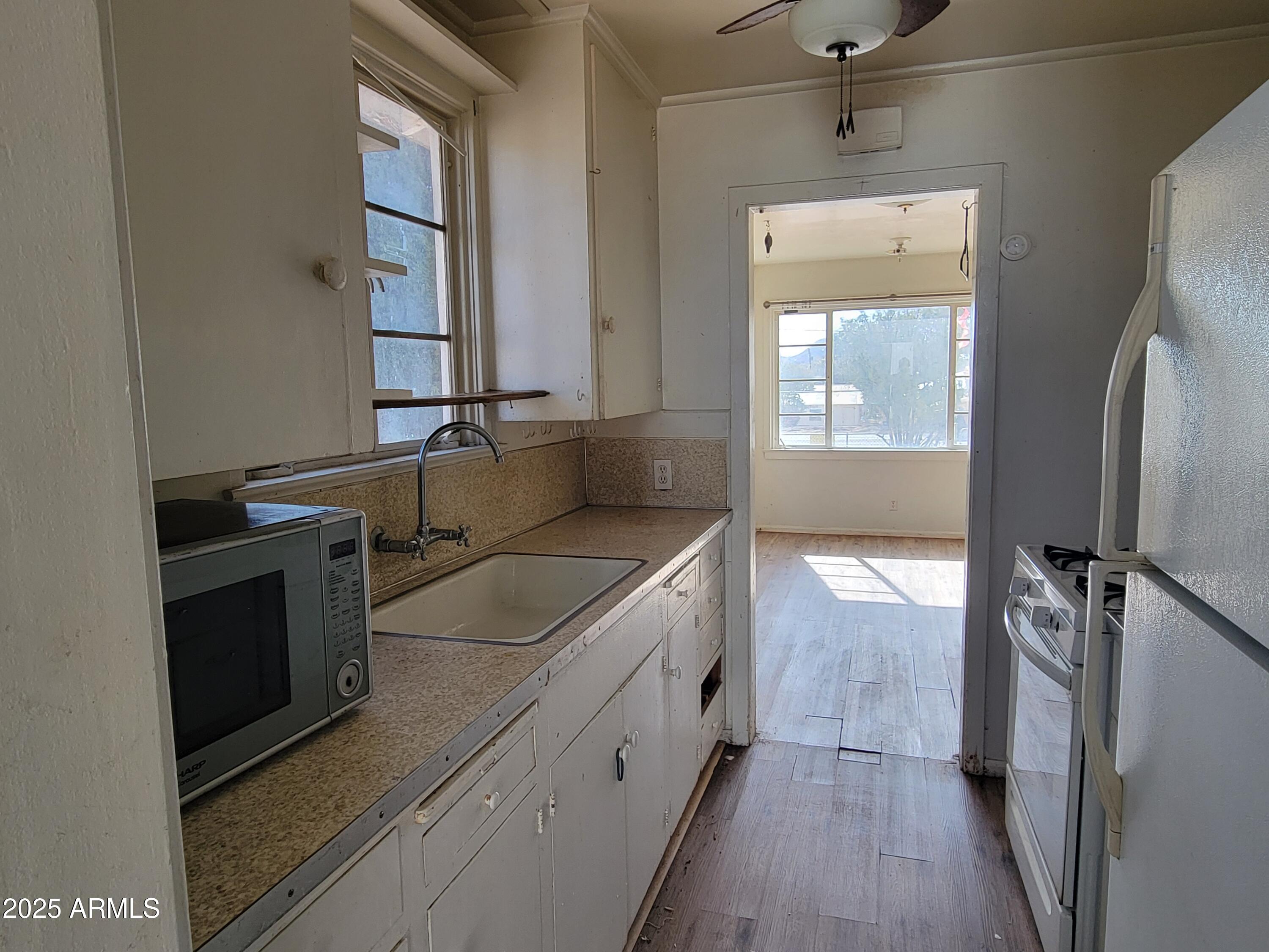 53 Spray Avenue Bisbee, AZ 85603 - Photo 5 of 21 a kitchen with a sink stove and refrigerator