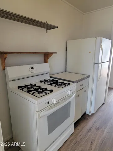 a white stove top oven sitting inside of a kitchen