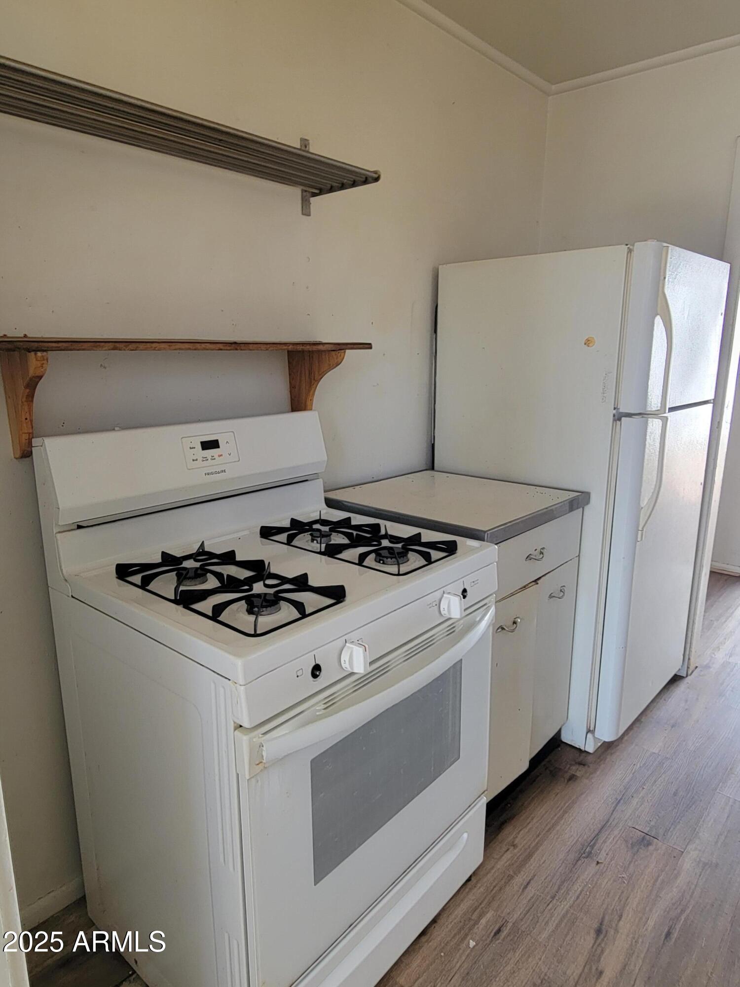 53 Spray Avenue Bisbee, AZ 85603 - Photo 6 of 21 a white stove top oven sitting inside of a kitchen
