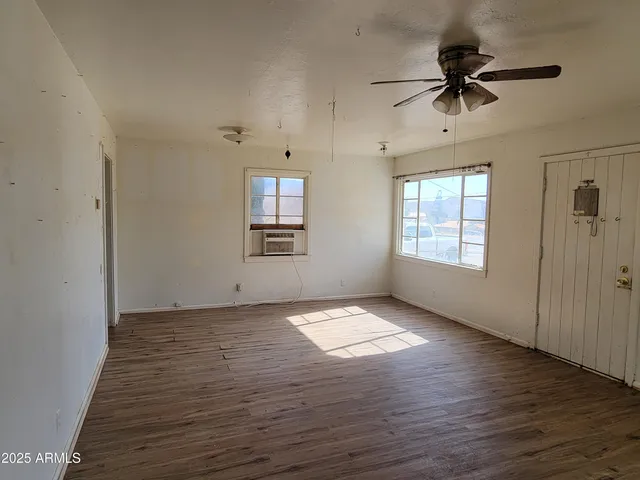 wooden floor in an empty room with a window