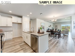 563 East Cleveland Street Carlton, OR 97111 - Photo 5 of 7 a kitchen with lots of counter top space and painting on the wall