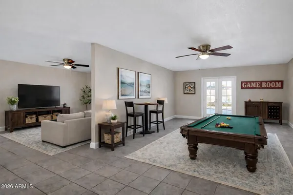 a living room with furniture a flat screen tv and a table
