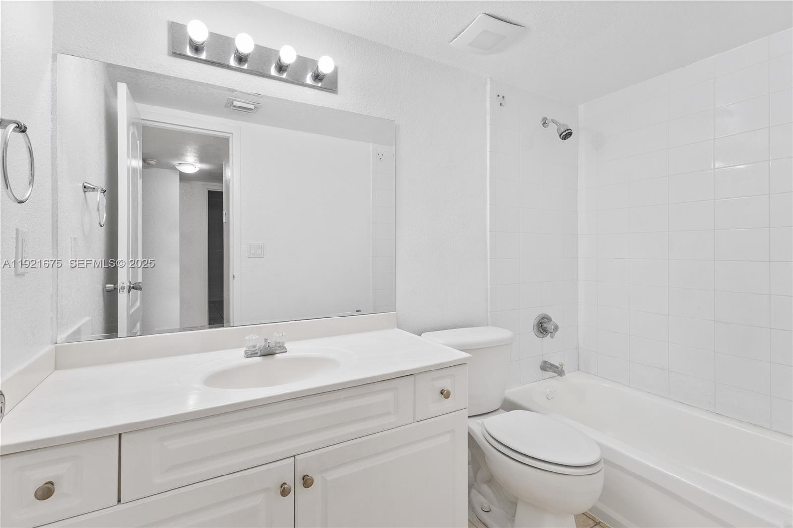5102 Northwest 79th Avenue, Unit 304 Doral, FL 33166 - Photo 20 of 25 a bathroom with a sink a toilet and shower