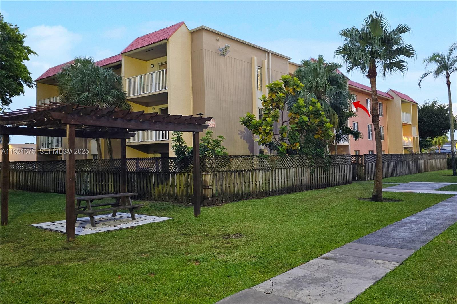 5102 Northwest 79th Avenue, Unit 304 Doral, FL 33166 - Photo 24 of 25 a view of a backyard with a small cabin and a chair