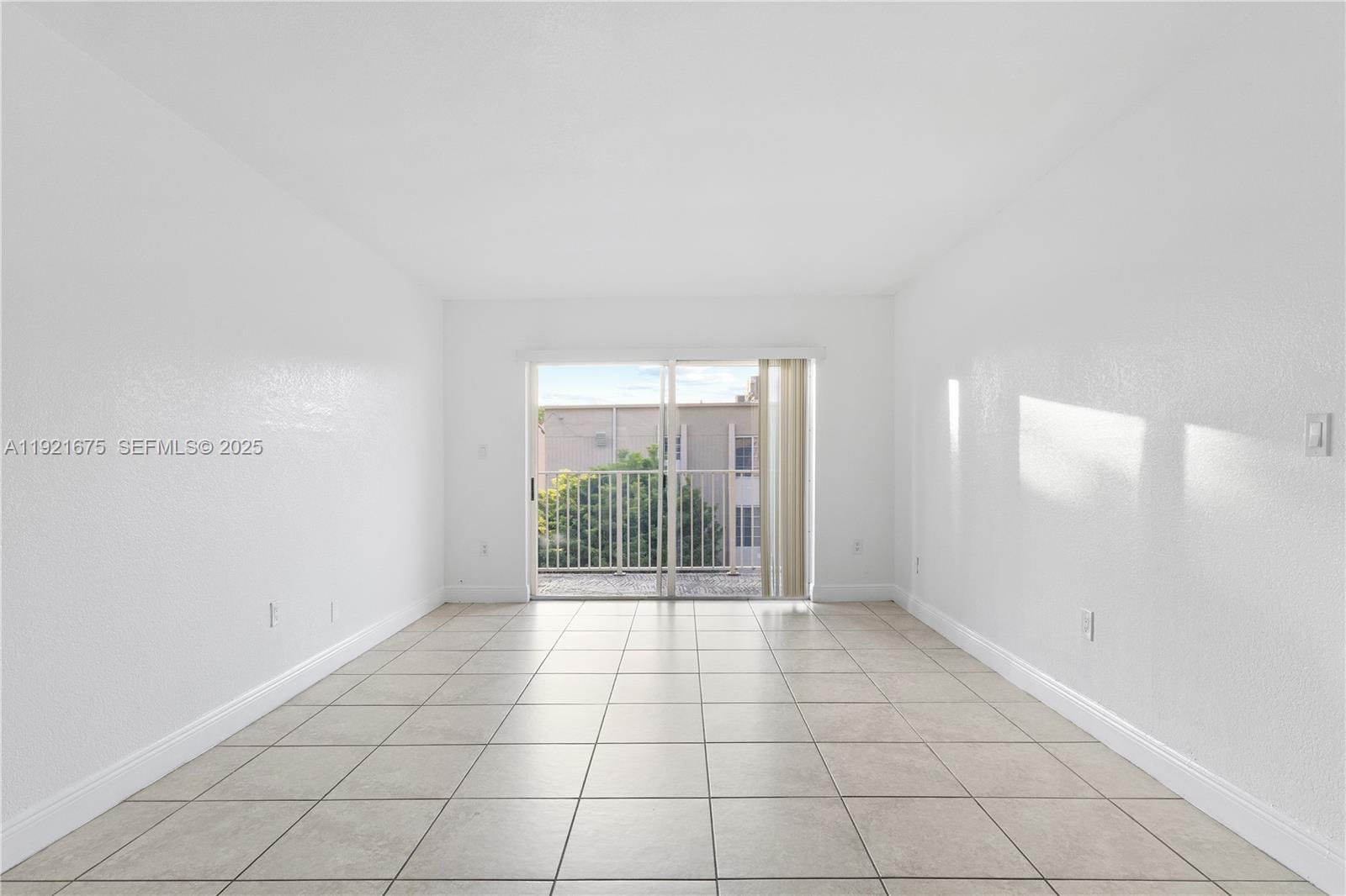 5102 Northwest 79th Avenue, Unit 304 Doral, FL 33166 - Photo 6 of 25 a view of an empty room with a window