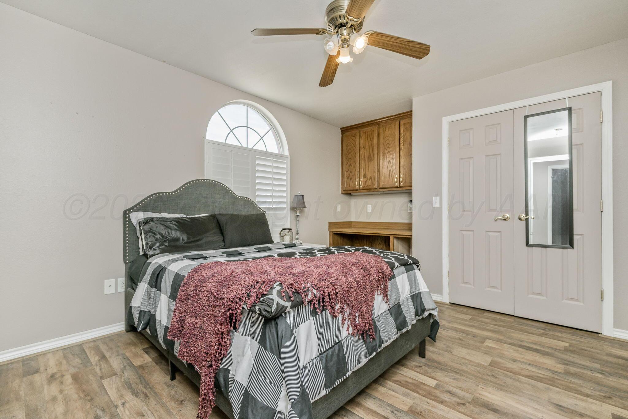 200 Hunters Trail Amarillo, TX 79124 - Photo 15 of 23 a bedroom with a bed and wooden floor