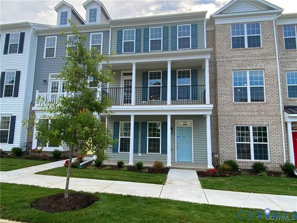 a front view of a house with yard and green space