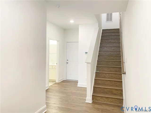 a view of a hallway with wooden floor