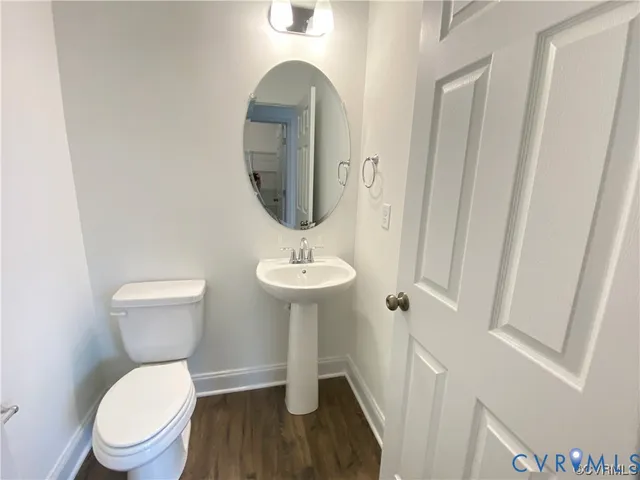 a bathroom with a toilet a sink and a mirror