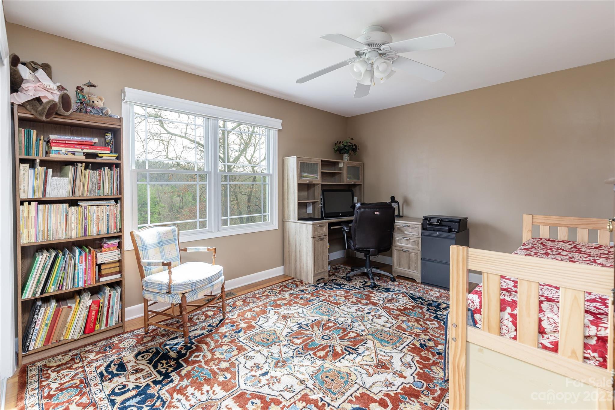 36 Wild Wind Trail Fairview, NC 28730 - Photo 20 of 33 a living room with a baby crib furniture a book shelf and a window