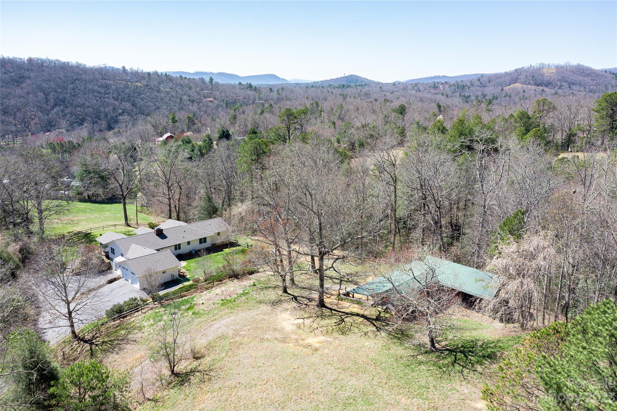 36 Wild Wind Trail Fairview, NC 28730 - Photo 23 of 33 an aerial view of a forest with mountain