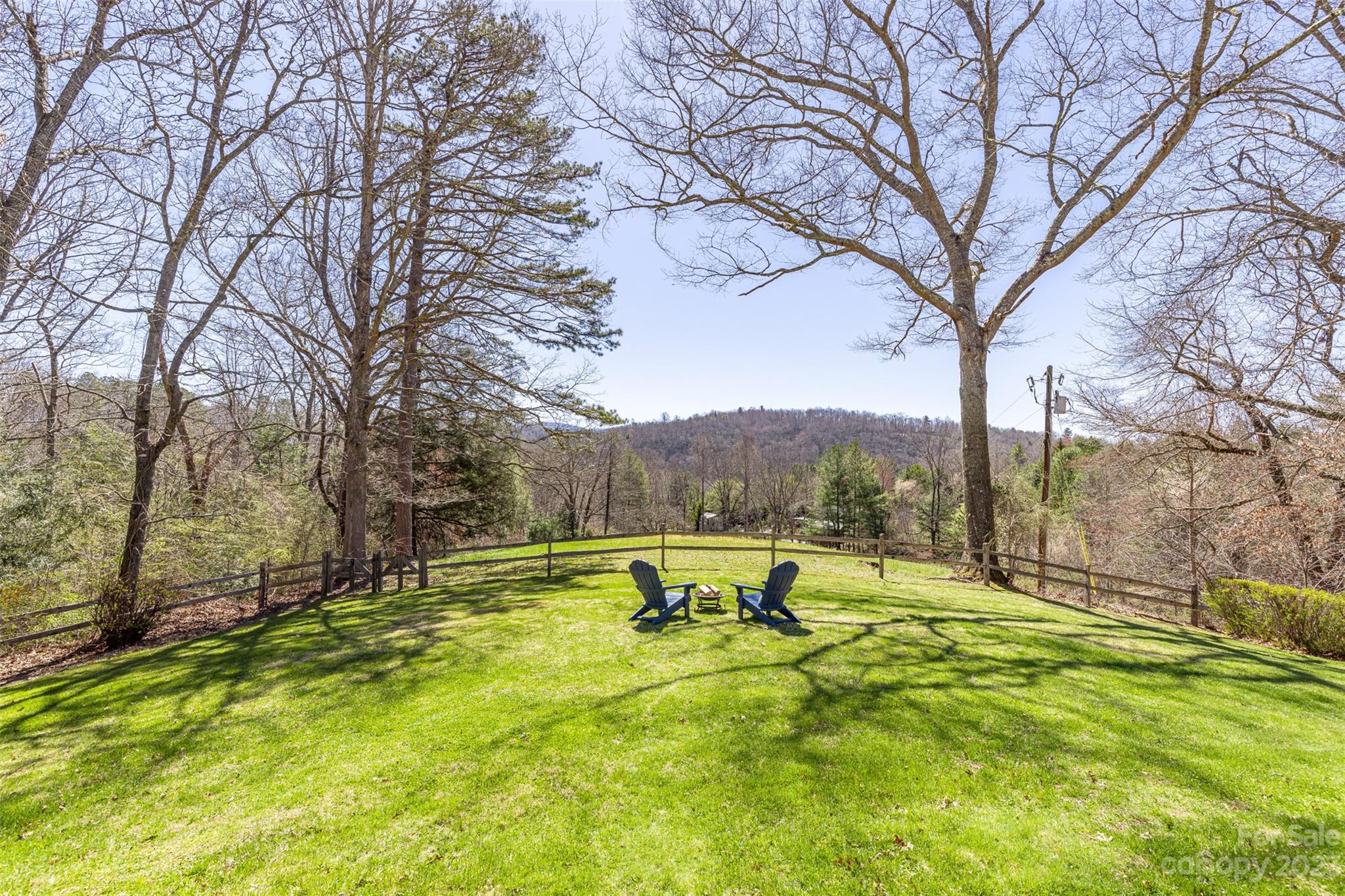 36 Wild Wind Trail Fairview, NC 28730 - Photo 5 of 33 a view of a swimming pool with a bench and trees