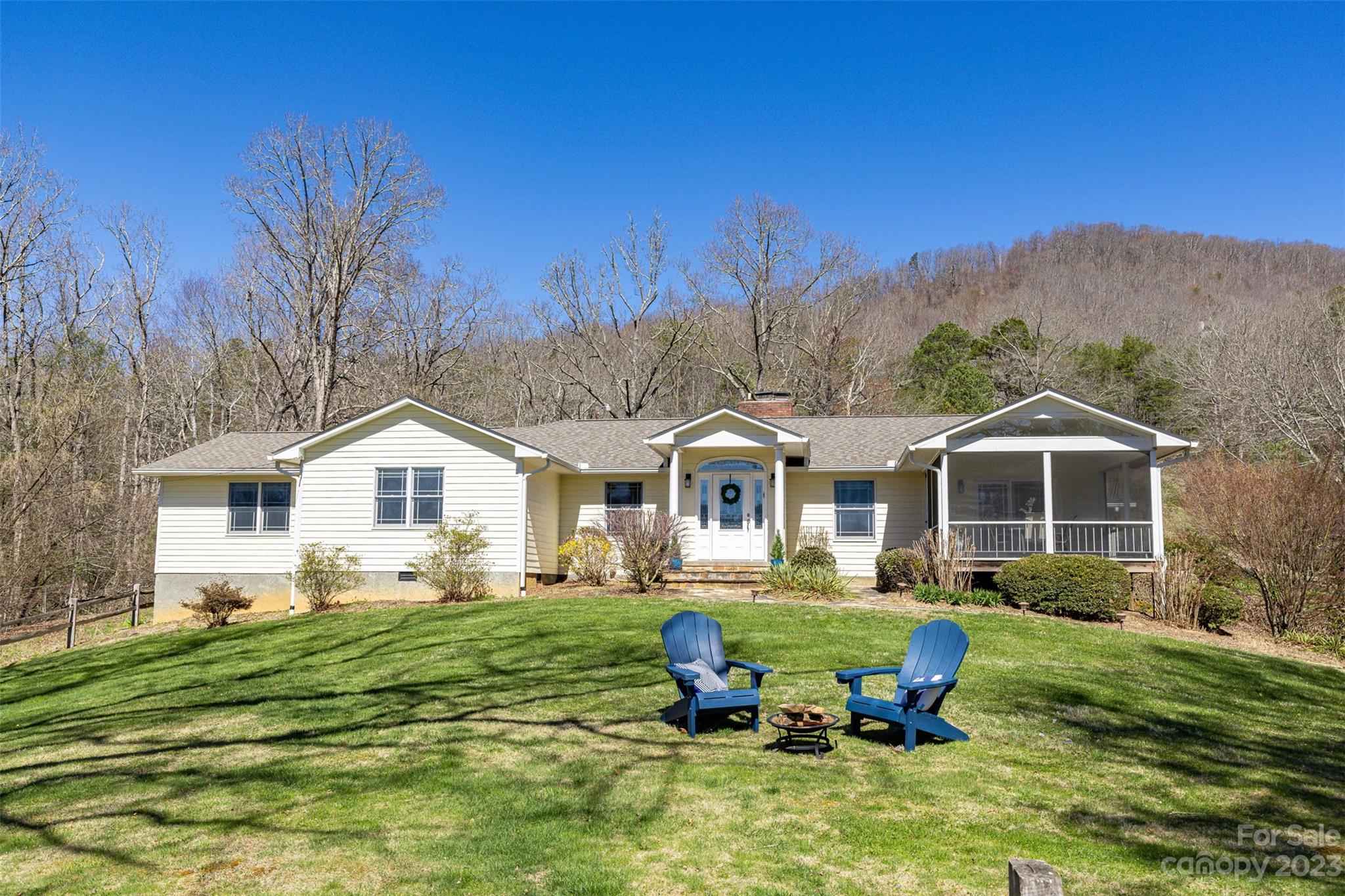 36 Wild Wind Trail Fairview, NC 28730 - Photo 7 of 33 a front view of a house with a garden and trees