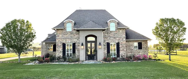 a front view of house with a garden