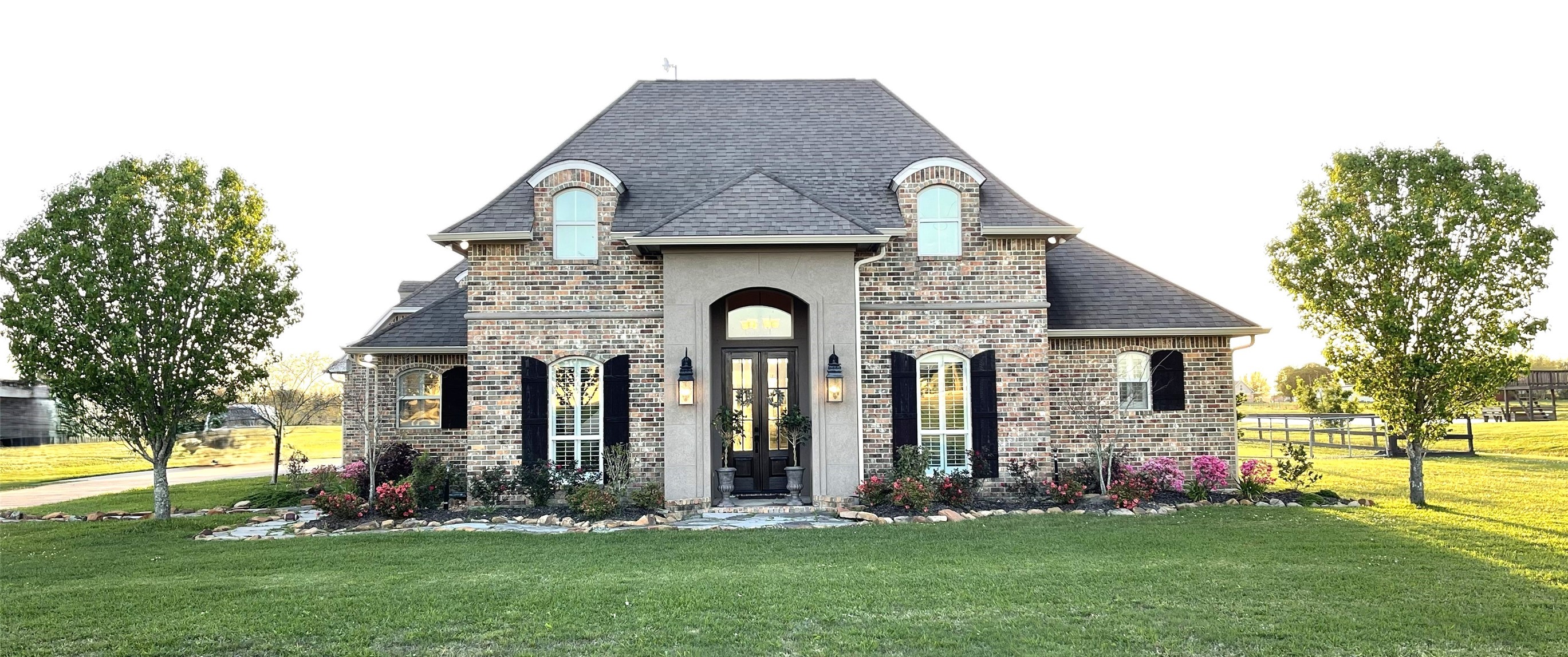 a front view of house with a garden