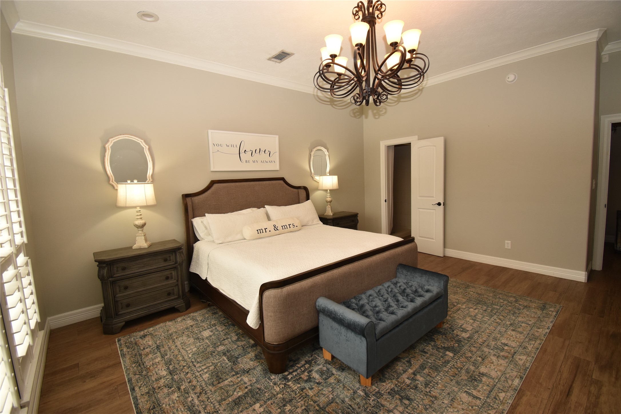 11620 Ridgecrest Beaumont, TX 77705 - Photo 9 of 20 a bedroom with a bed and a chandelier