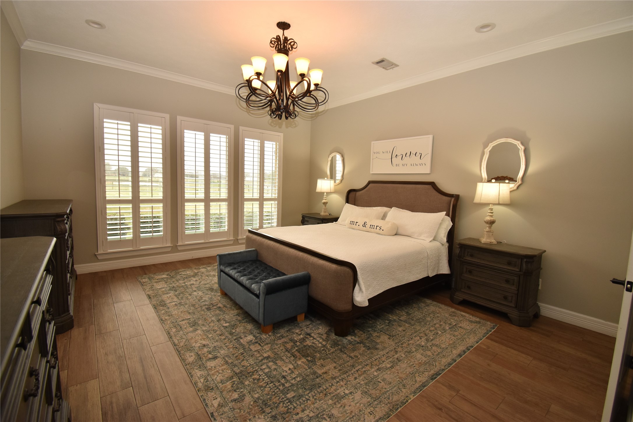 11620 Ridgecrest Beaumont, TX 77705 - Photo 10 of 20 a spacious bedroom with a bed and a chandelier