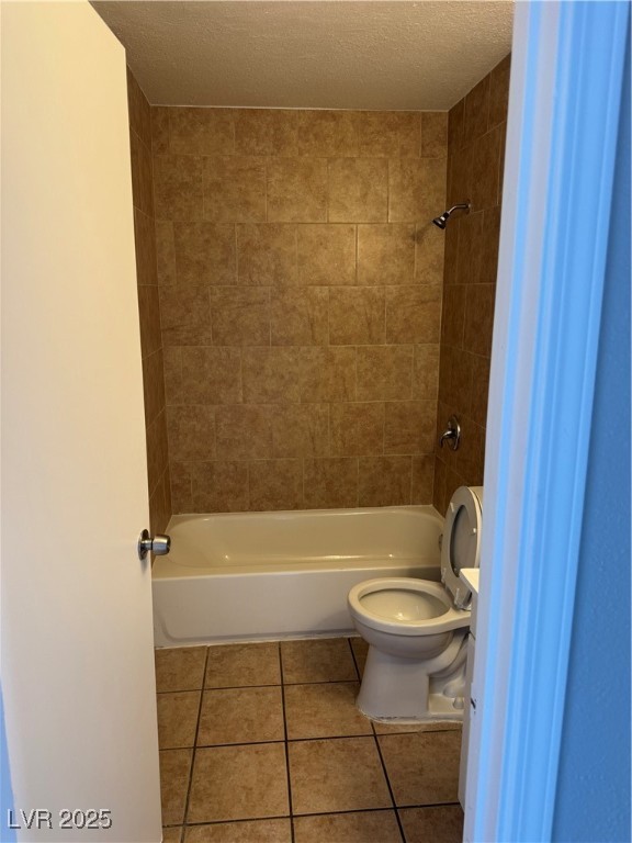 6925 Hopkins Drive, Unit 4 Las Vegas, NV 89156 - Photo 9 of 12 Full bathroom featuring shower / bath combination, tile patterned floors, and a textured ceiling