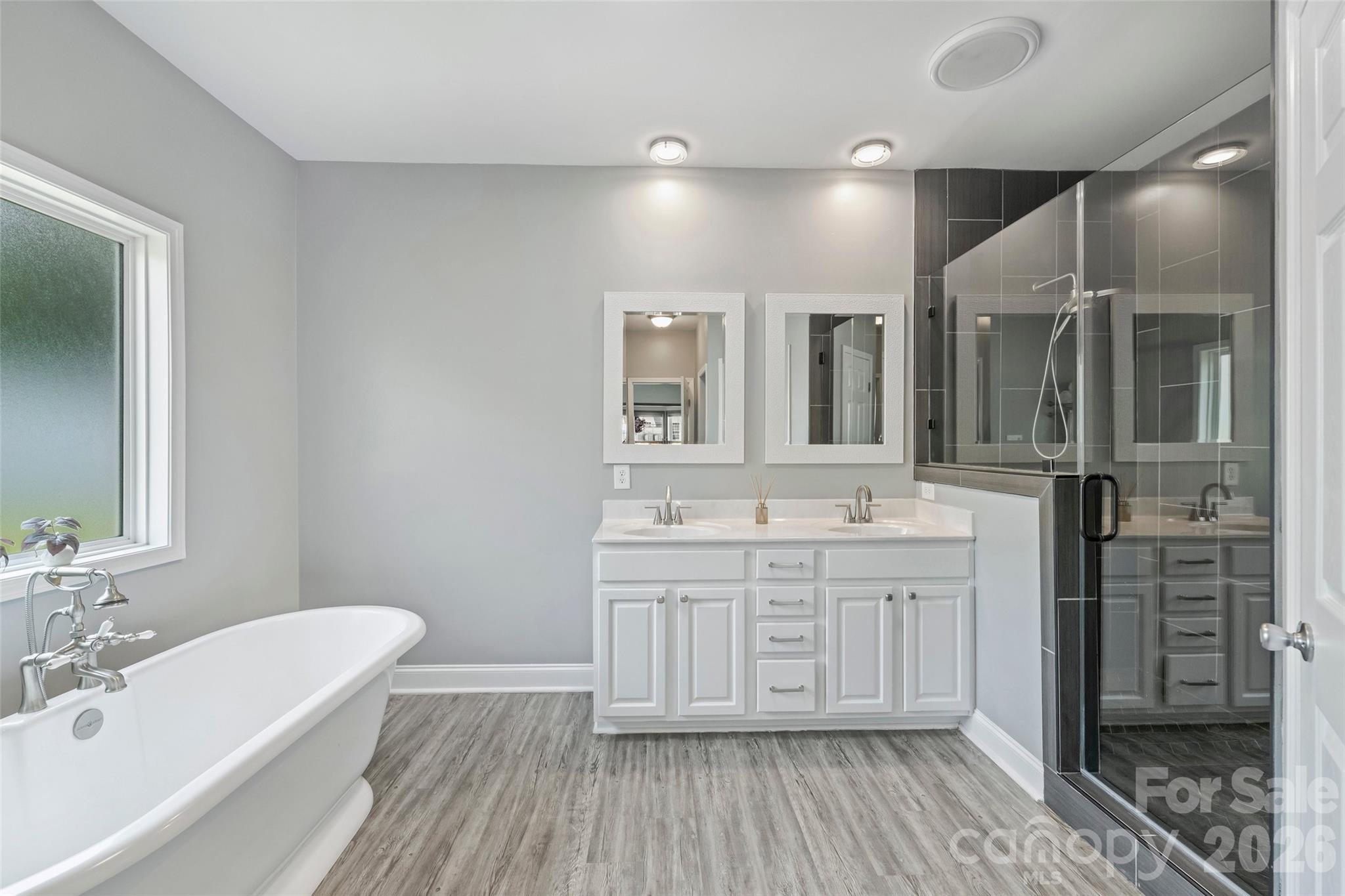 2500 Grayson Parkway Monroe, NC 28110 - Photo 23 of 41 a spacious bathroom with a double vanity sink a mirror and a bathtub