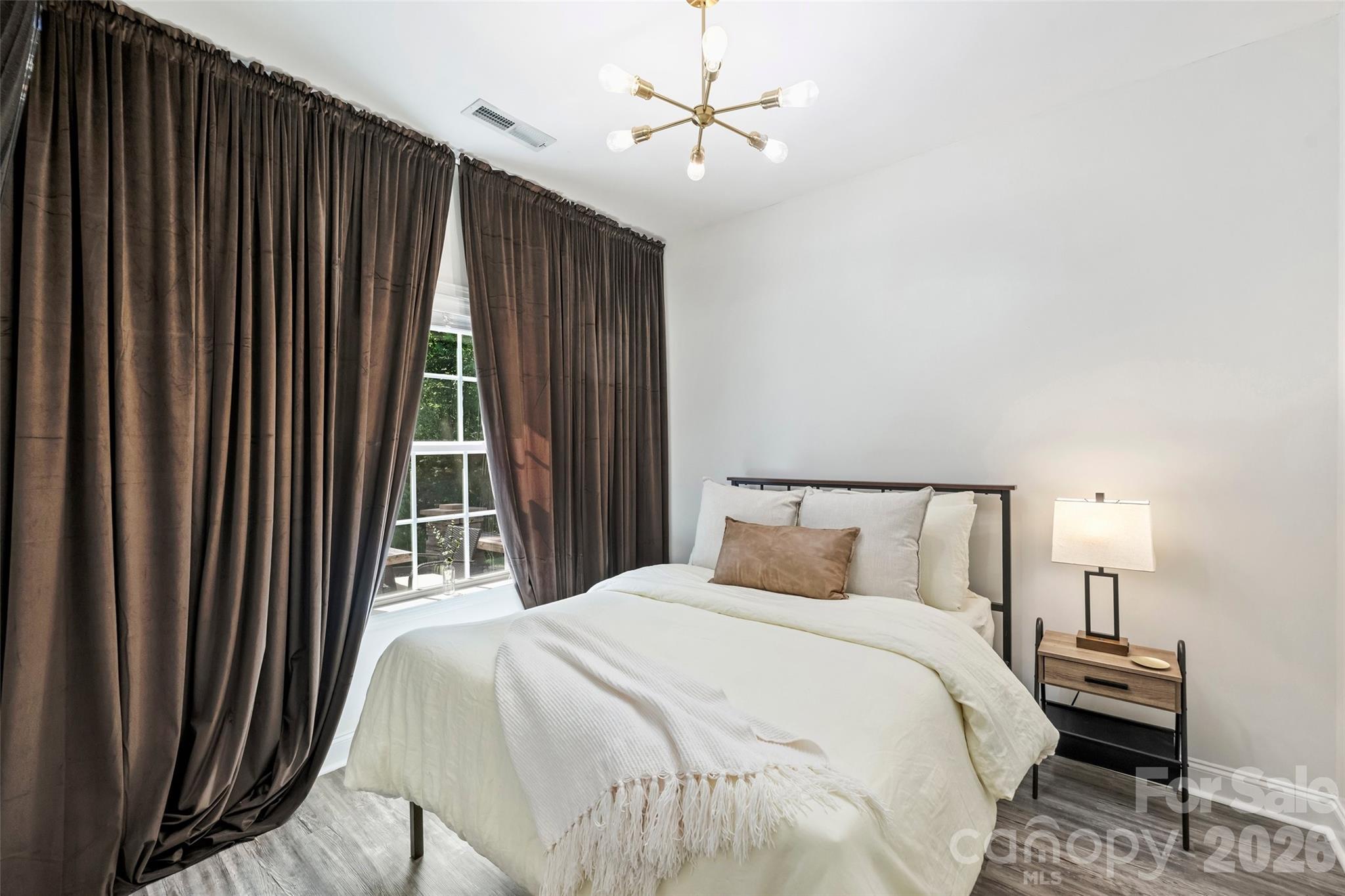 2500 Grayson Parkway Monroe, NC 28110 - Photo 27 of 41 a bedroom with a bed and a chandelier