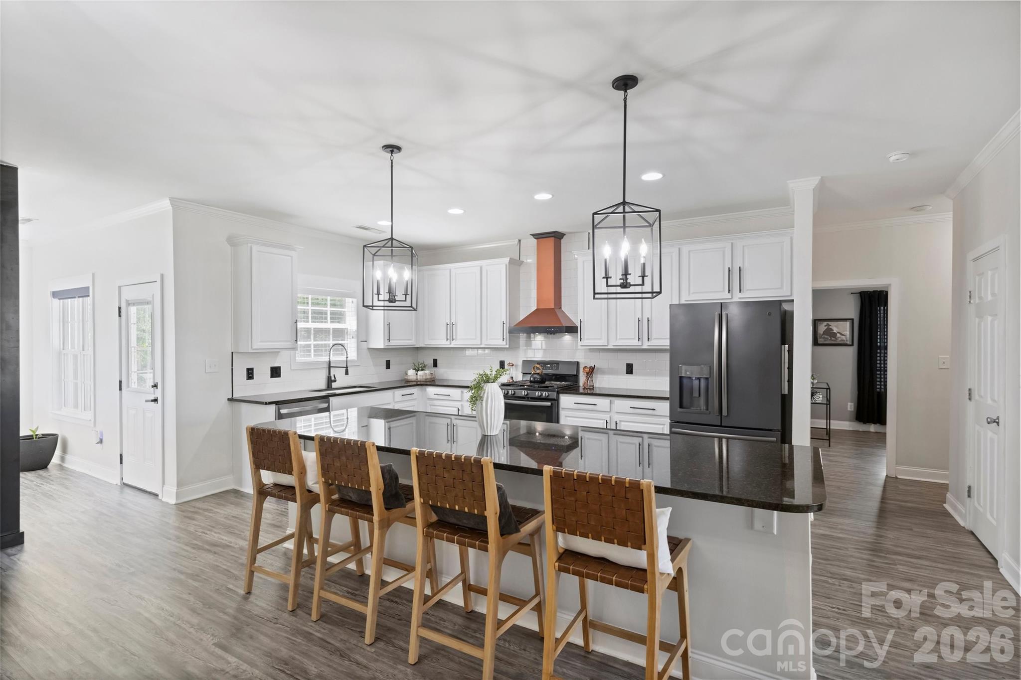 2500 Grayson Parkway Monroe, NC 28110 - Photo 10 of 41 a kitchen with stainless steel appliances kitchen island granite countertop a dining table chairs and white cabinets