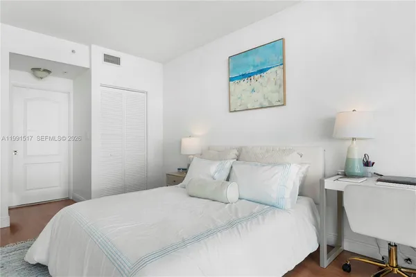 a bedroom with a bed and a table in it
