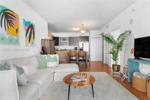 a living room with furniture and a flat screen tv
