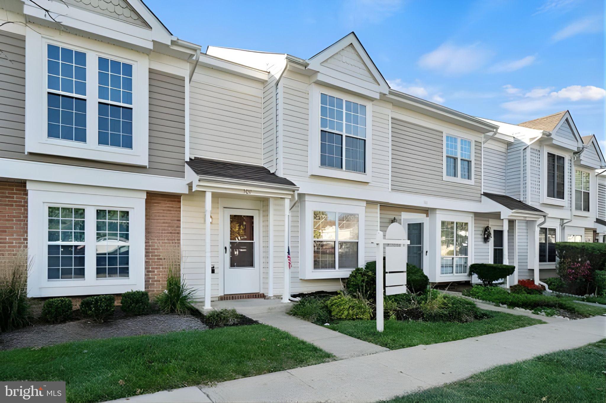 107 St Charles Square Sterling, VA 20164 - Photo 1 of 27 a view of a white house next to a yard