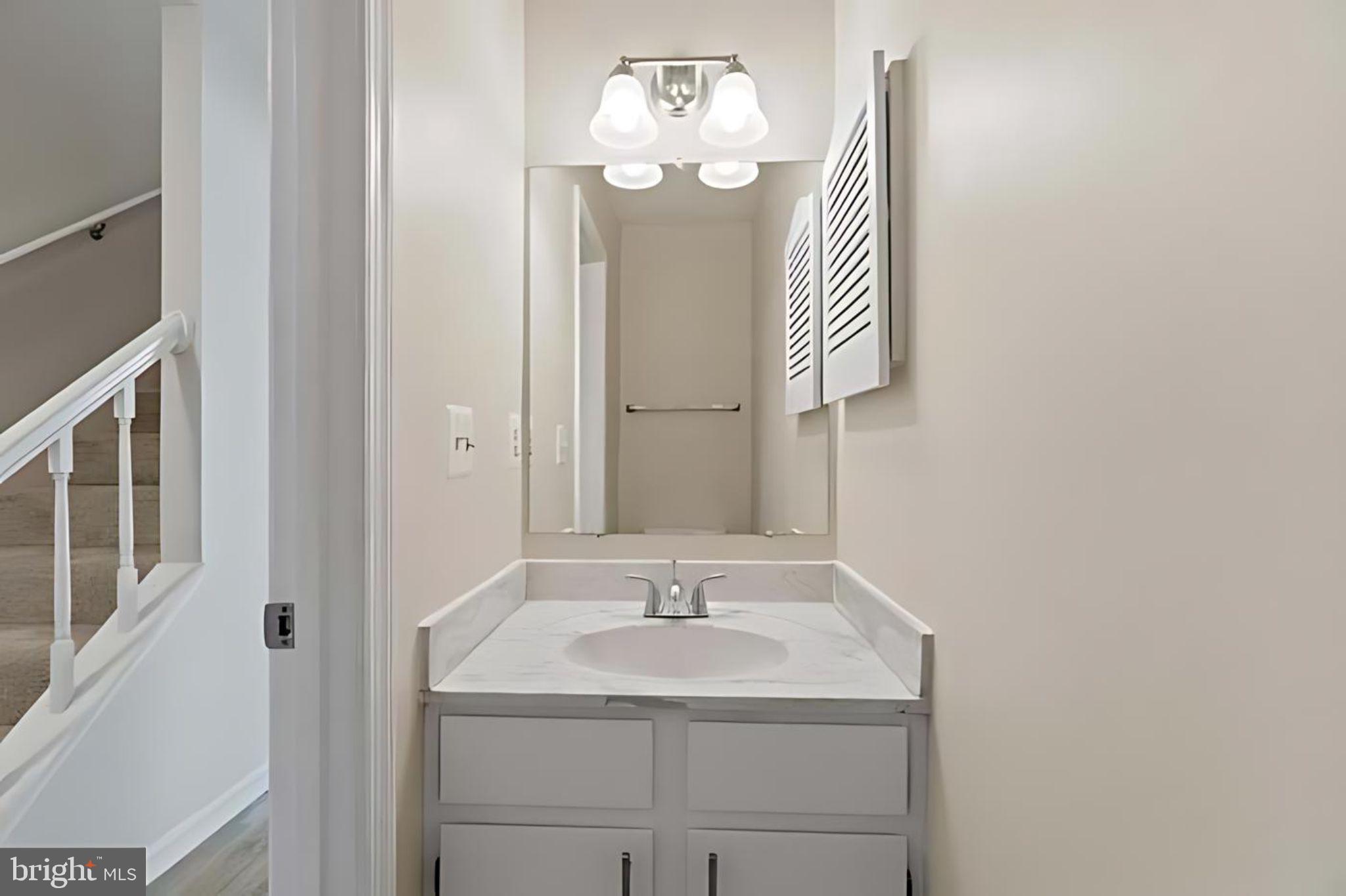 107 St Charles Square Sterling, VA 20164 - Photo 12 of 27 a bathroom with a sink and a mirror