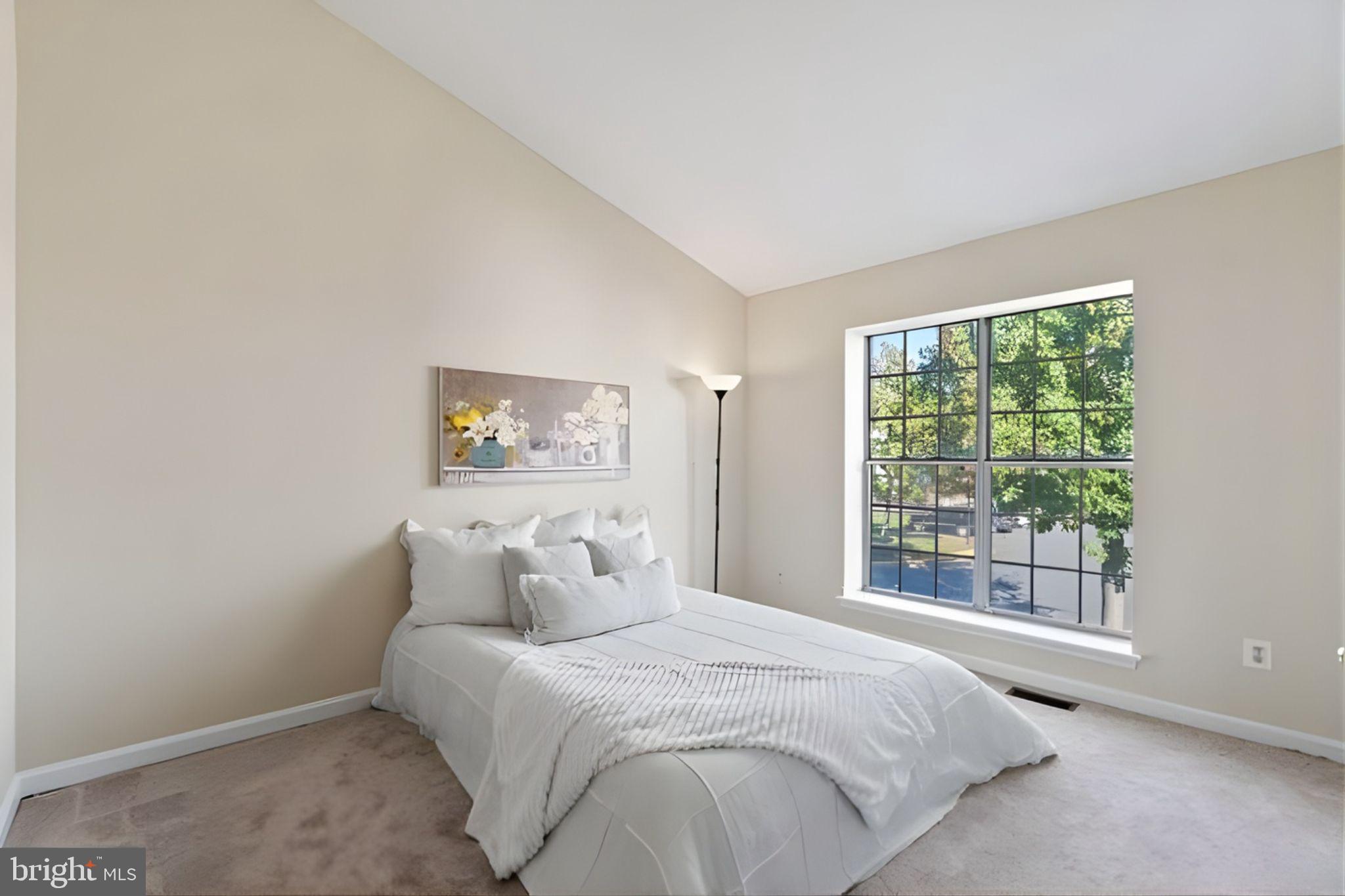 107 St Charles Square Sterling, VA 20164 - Photo 16 of 27 a spacious bedroom with a bed and a large window