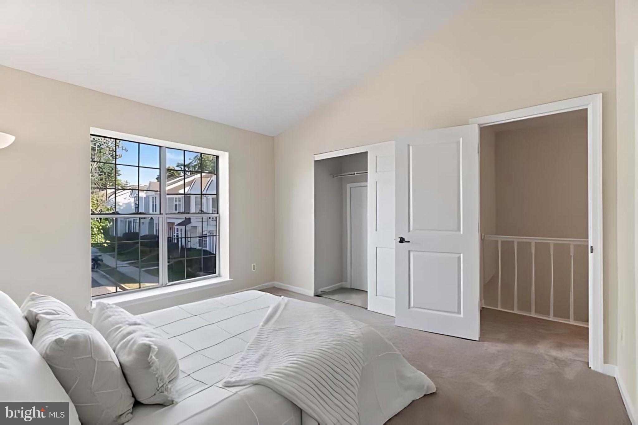 107 St Charles Square Sterling, VA 20164 - Photo 17 of 27 a bedroom with a bed and a large window
