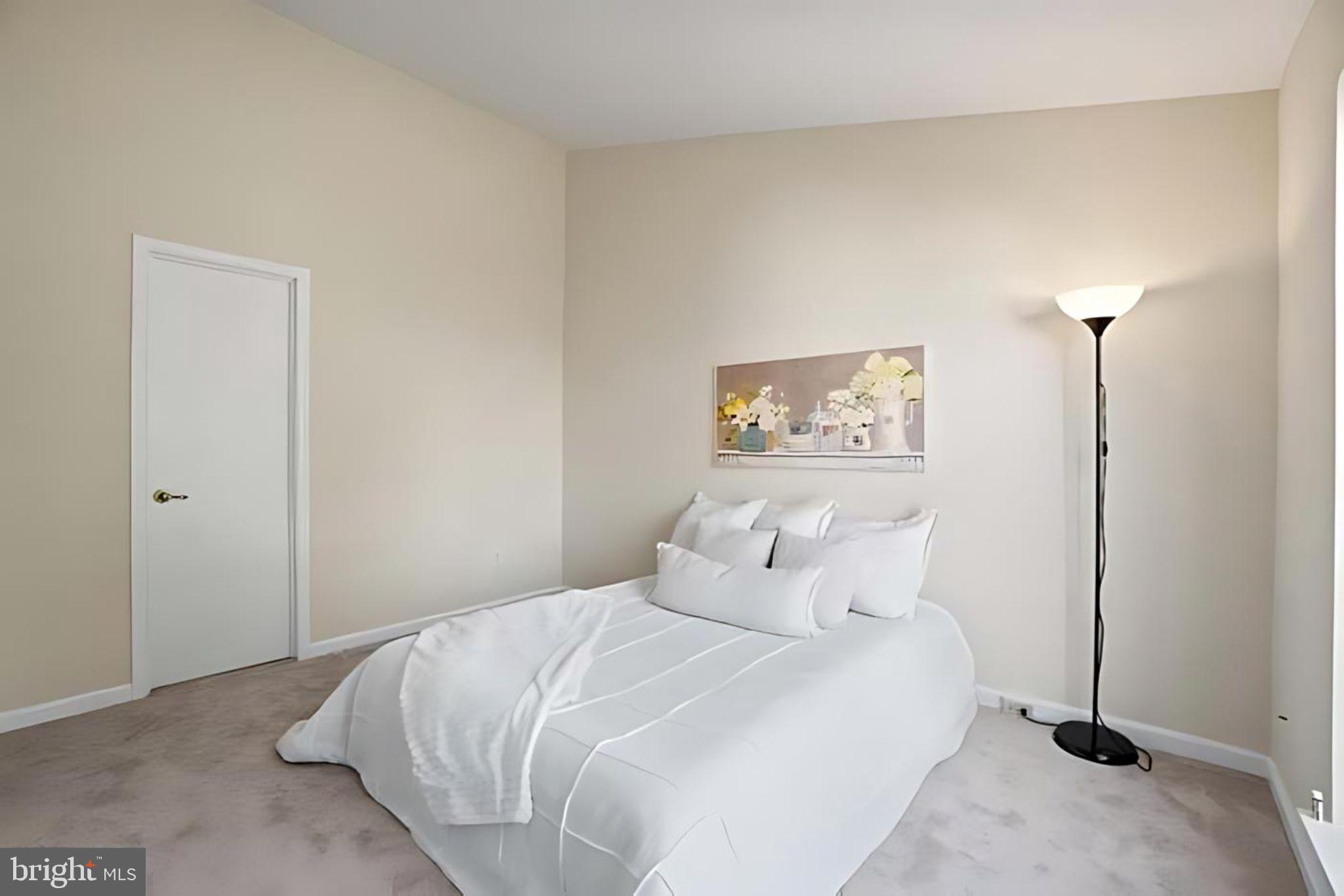 107 St Charles Square Sterling, VA 20164 - Photo 18 of 27 a bedroom with a bed and a night stand