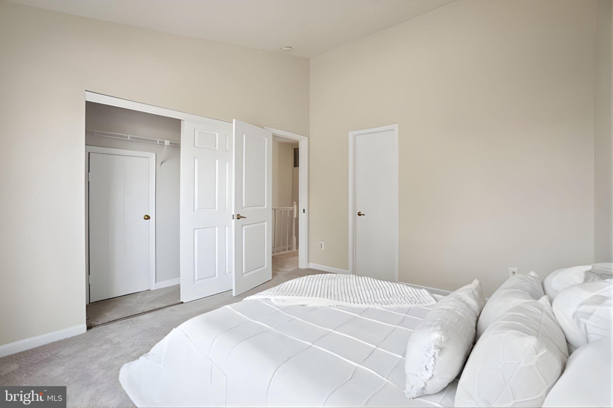 107 St Charles Square Sterling, VA 20164 - Photo 19 of 27 a bedroom with a bed and a mirror