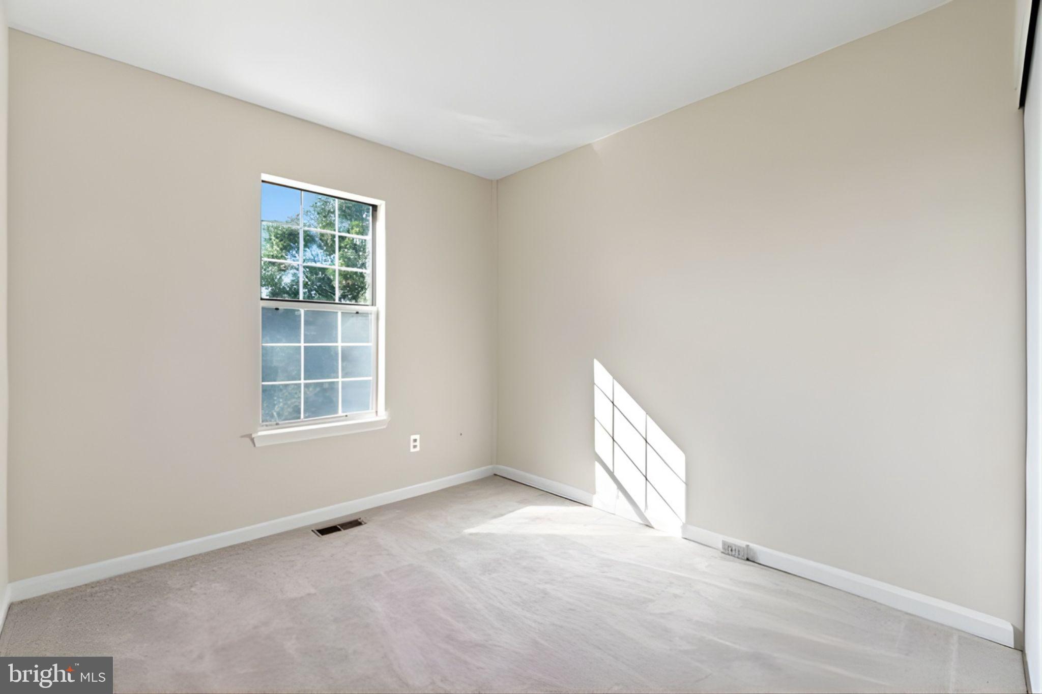 107 St Charles Square Sterling, VA 20164 - Photo 21 of 27 an empty room with a window
