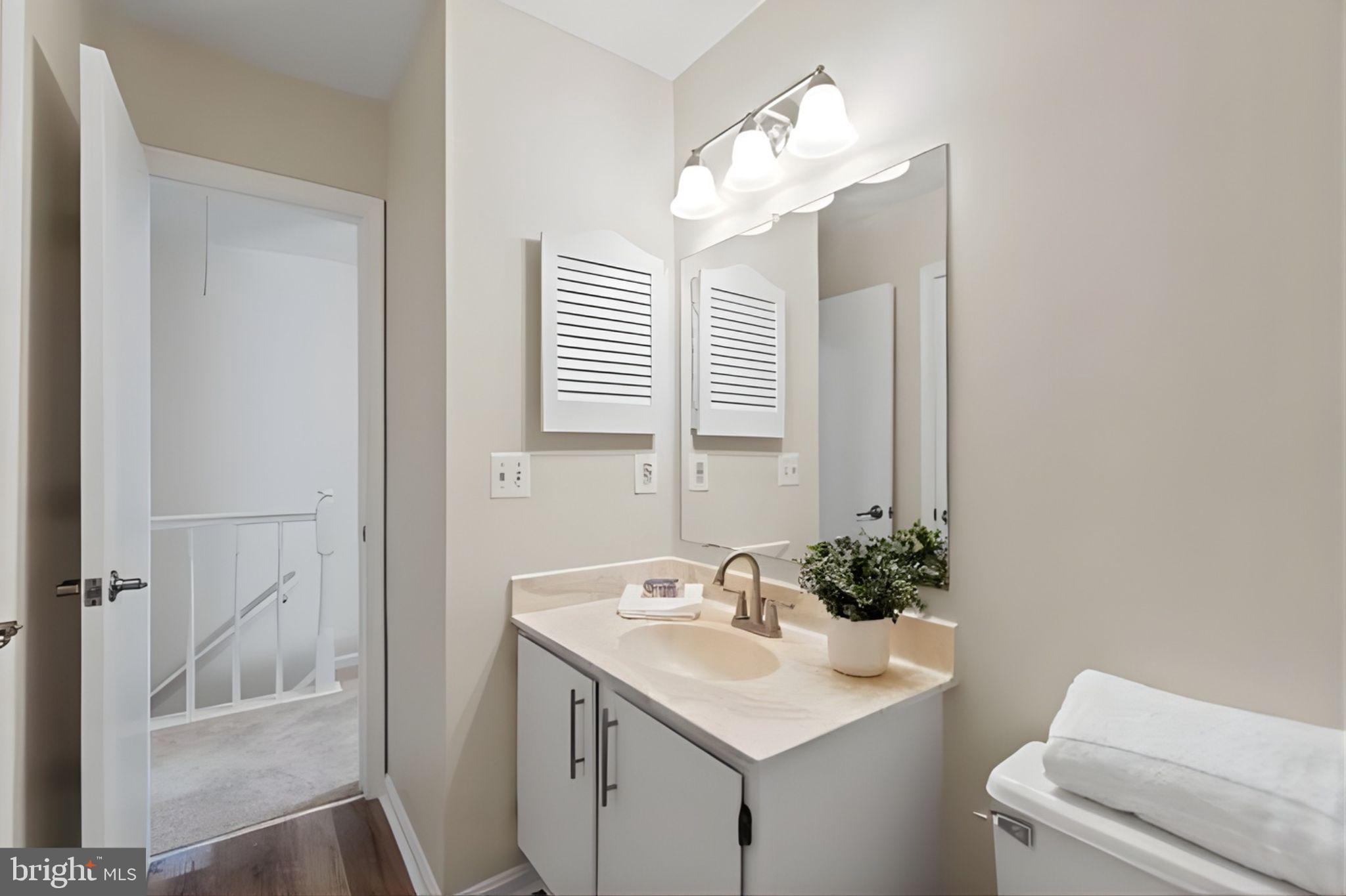 107 St Charles Square Sterling, VA 20164 - Photo 22 of 27 a bathroom with a sink and a mirror