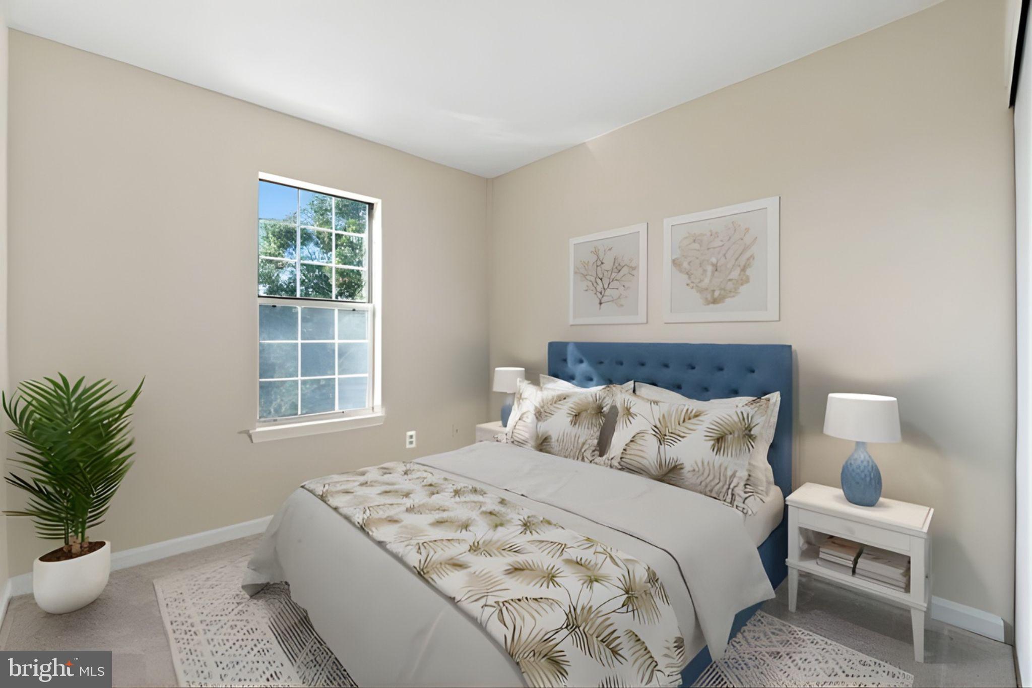 107 St Charles Square Sterling, VA 20164 - Photo 24 of 27 a bedroom with a bed and wooden floor