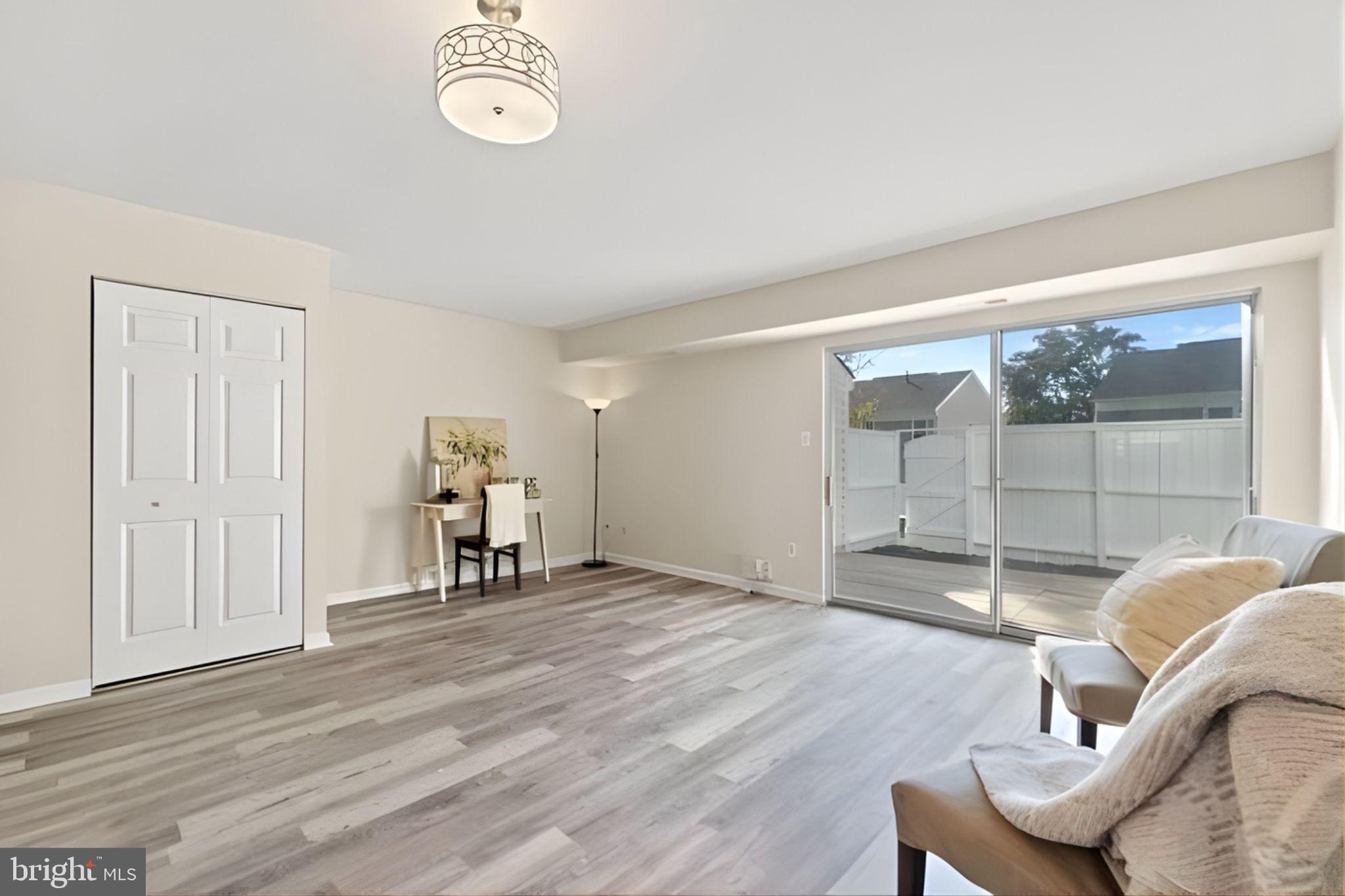 107 St Charles Square Sterling, VA 20164 - Photo 9 of 27 a view of a livingroom with furniture and wooden floor
